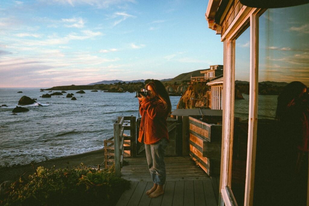 Woman doing photography by beach