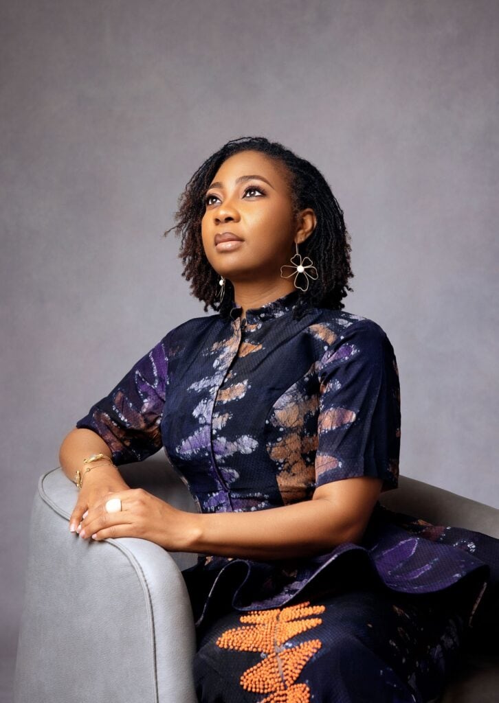 Headshot of Black business woman wearing blue floral shirt.